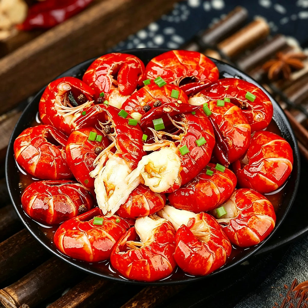 Plate of glossy red cooked crayfish tails garnished with coriander