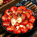 Plate of glossy red cooked crayfish tails garnished with coriander