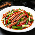 Stir-fried sea intestines with Chinese chives on a white plate